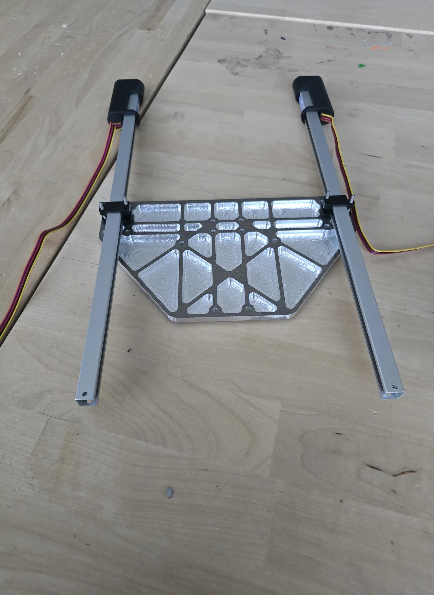 Elevator frame: 1 × 1/2 in tubes and the water-jet lattice carriage